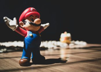 Super Mario figurine on brown surface